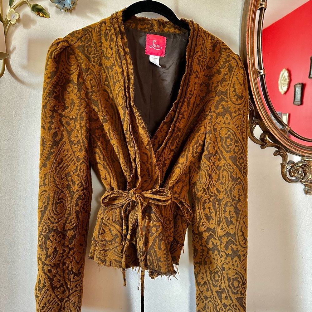 Vintage-y from Anthropologie. Distressed look. Large fits like a medium.